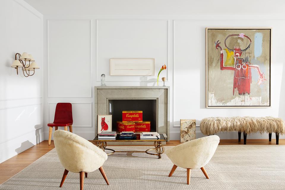 The living room features artworks by Warhol, Richard Prince, and Jean-Michel Basquiat alongside Jean Royère furnishings.