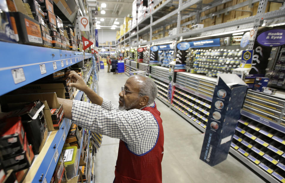 FILE - In this Feb. 23, 2018, file photo sales associate Larry Wardford, of Holliston, Mass., places items on selves at a Lowe's retail home improvement and appliance store, in Framingham, Mass. Lowe's Companies, Inc. reports financial results Wednesday, Aug. 21, 2019. (AP Photo/Steven Senne, File)