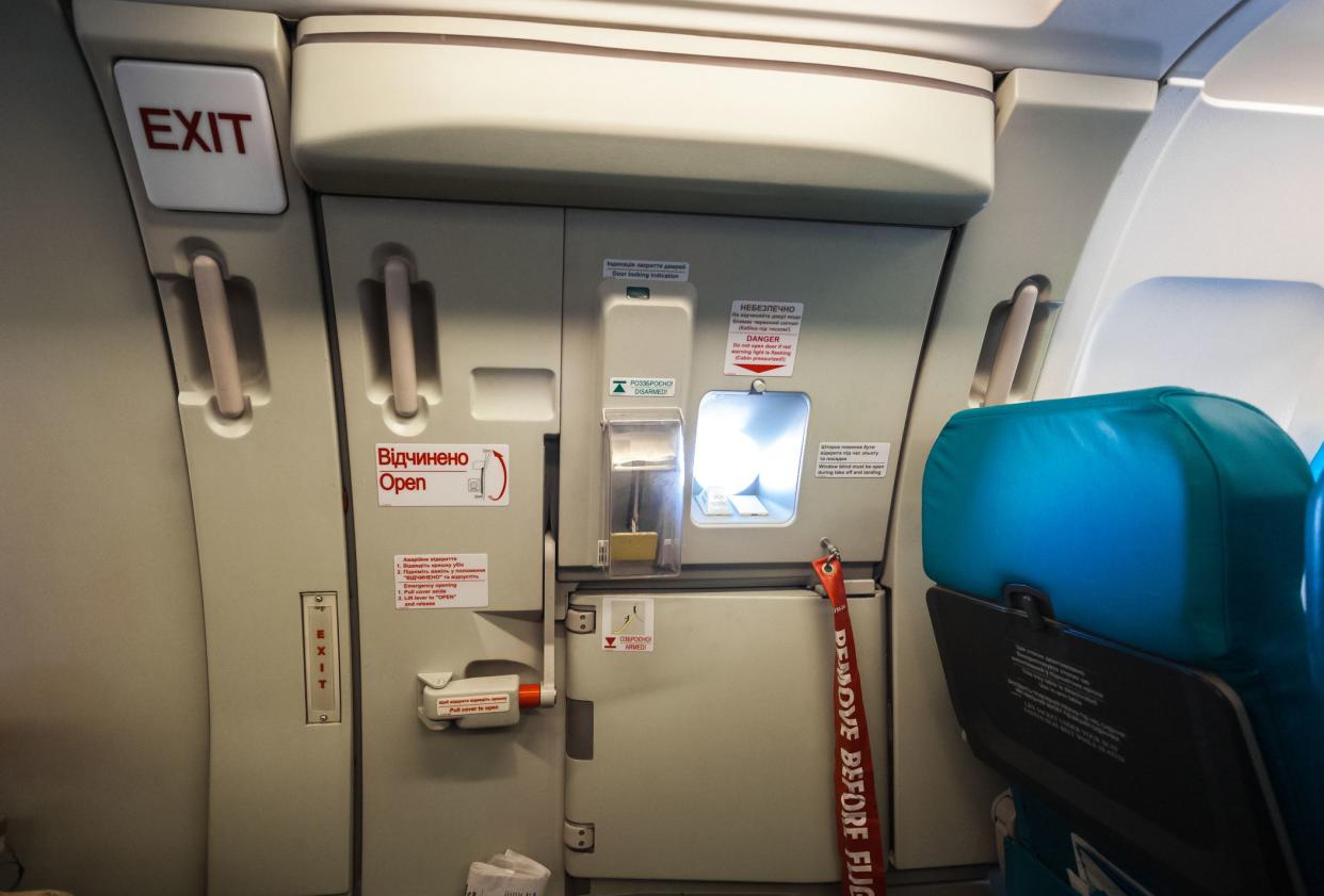 Closeup shot of emergency exit door in airplane