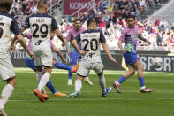 AC Milan's Christian Pulisic, background left, scores his side's opening goal during the Serie A soccer match between AC Milan and Lecce at the San Siro stadium, in Milan, Italy, Saturday, April 6, 2024. (AP Photo/Antonio Calanni)