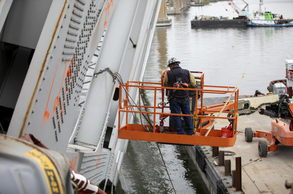 In this photo provided by the U.S. Army Corps of Engineers, salvors with the Unified Command prepare charges for upcoming precision cuts to remove Section 4 from the port side of the bow of the Dali container ship, April 21, 2024, during the Key Bridge Response, in Baltimore. Debris and wreckage removal is ongoing in support of safely and efficiently opening the Fort McHenry Channel, following the Francis Scott Key Bridge’s March 26 collapse. (Christopher Rosario/U.S. Army Corps of Engineers via AP)