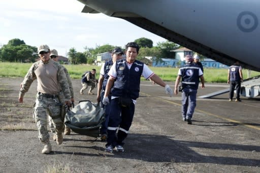 Military personel and members of a health brigade unload equipment from a plane, to be used in areas affected by a quake, in Yurimaguas in Peru's Amazon region