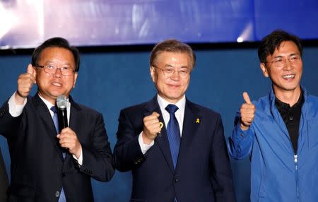 South Korea's president-elect Moon Jae-in and South Chungcheong governor An Hee-jung (R) celebrate with supporters at Gwanghwamun Square in Seoul, South Korea, May 10, 2017. REUTERS/Kim Kyung-hoon