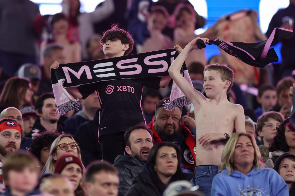 Fans in the stands cheer on Lionel Messi during the second half of Saturday night's game against the New England Revolution at Gillette Stadium.