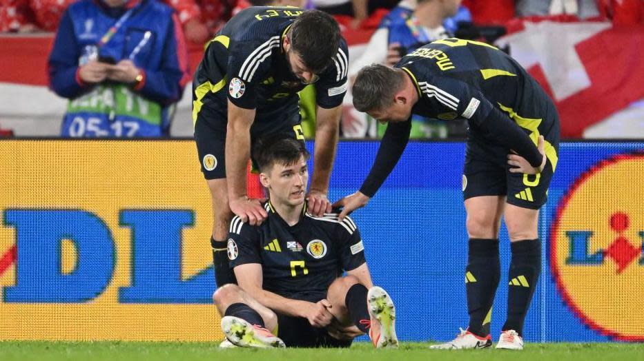 Scotland's Kieran Tierney is consoled by team-mates