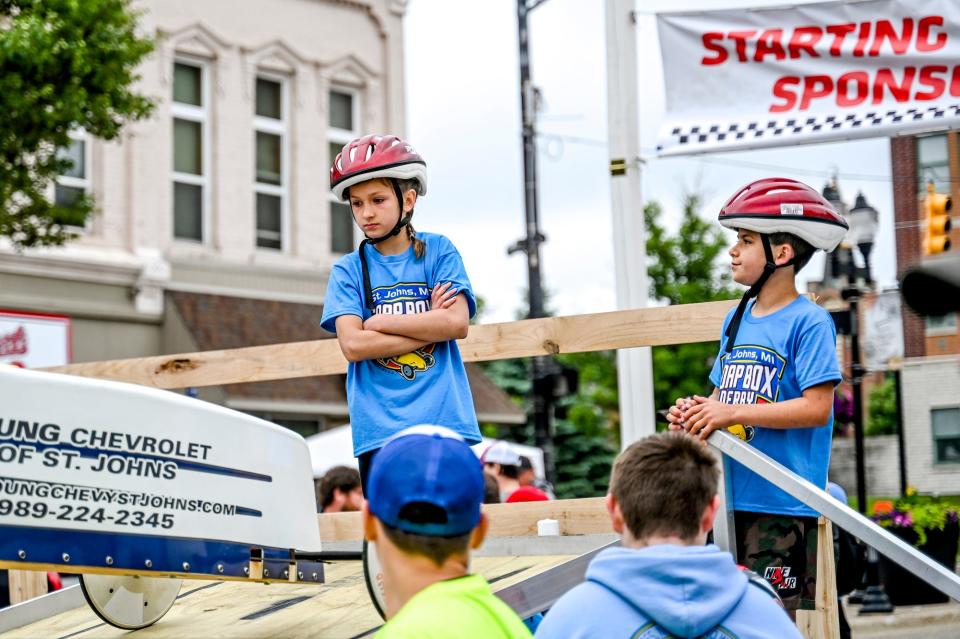 Racers Payton Gingrich, 9, left, and Louie Doud, 9, wait at the starting ramp before their heat during the St. Johns Soap Box Derby on Sunday, June 11, 2023, in downtown St. Johns.