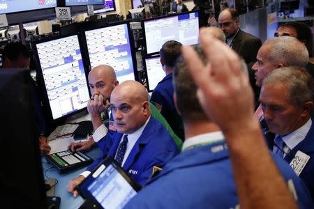 Traders work on the floor of the New York Stock Exchange (NYSE) as the market closes in New York, U.S., October 3, 2016. REUTERS/Lucas Jackson