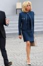 <p>Wearing a navy jacket and dress by Louis Vuitton, suede nude pumps, and a tan handbag at the annual Bastille Day military parade on the Champs-Elysees.</p>