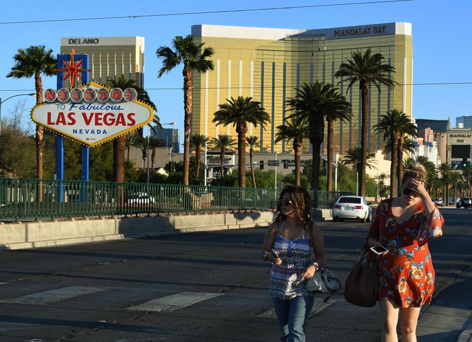 Two festivalgoers leave the area around the Mandalay Bay Hotel in Las Vegas on Oct. 2, 2017. (Photo: Mark Ralston/AFP/Getty Images)