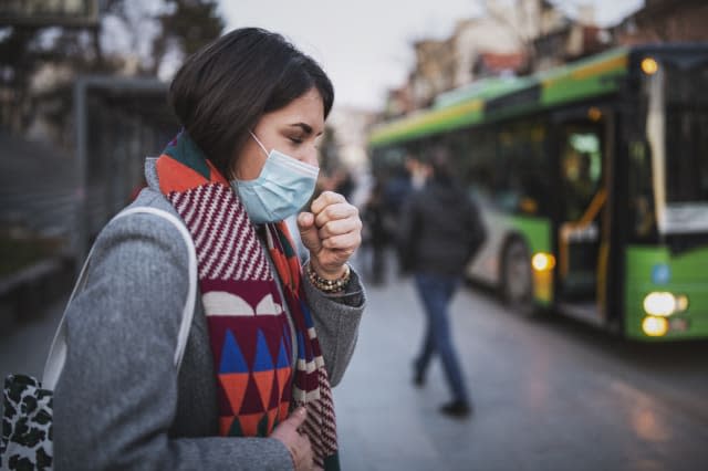 Woman Wear Face Mask And Coughing While Standing In The Town