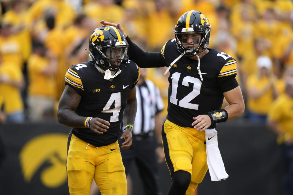 Iowa running back Leshon Williams (4) celebrates with teammate quarterback Cade McNamara (12) after catching a 25-yard touchdown pass during the first half of an NCAA college football game against Western Michigan, Saturday, Sept. 16, 2023, in Iowa City, Iowa. (AP Photo/Charlie Neibergall)