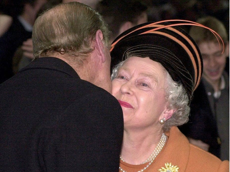 Prince Philip kisses Queen Elizabeth on the cheek in 2000.