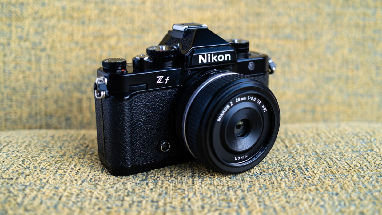  Nikon Z f camera on a vintage-style yellow chair. 