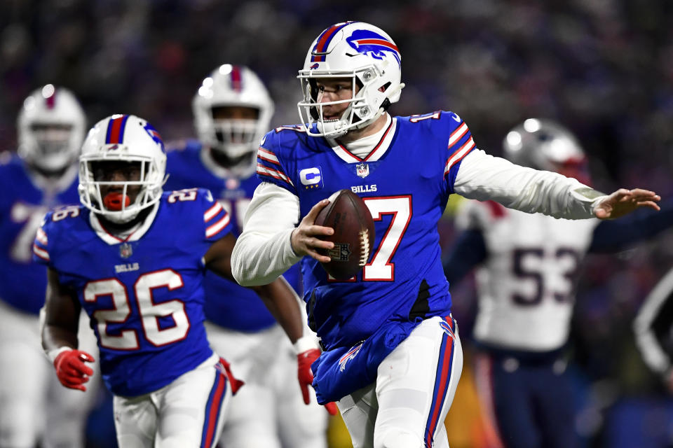 Buffalo Bills quarterback Josh Allen (17) runs the ball during the first half of an NFL wild-card playoff football game against the New England Patriots, Saturday, Jan. 15, 2022, in Orchard Park, N.Y. (AP Photo/Adrian Kraus)