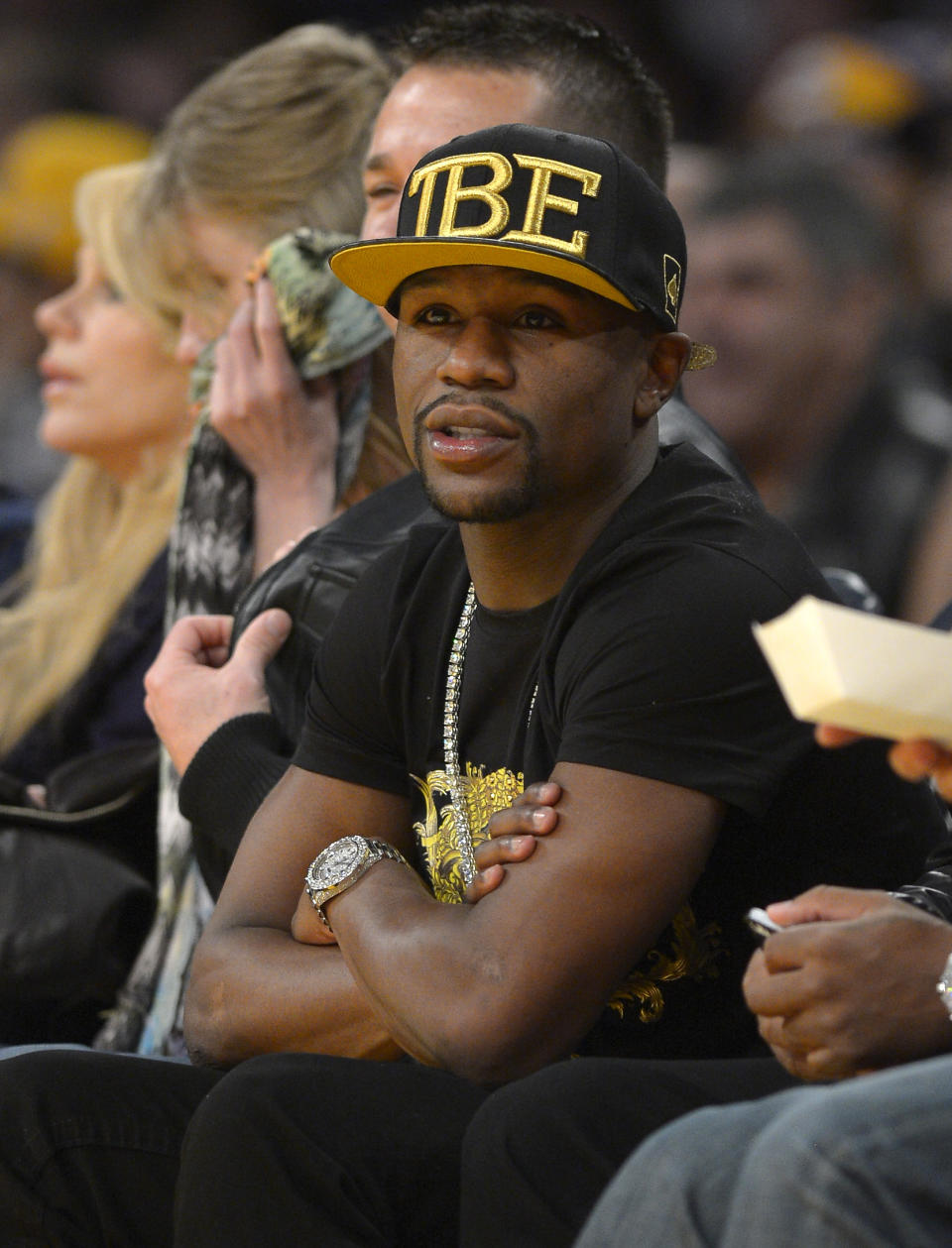 FILE - In this Nov. 24, 2013, file photo, Boxer Floyd Mayweather Jr. watches the Los Angeles Lakers play the Sacramento Kings during the first half of an NBA basketball game in Los Angeles. If Donald Sterling is compelled to sell the Los Angeles Clippers, the list of potential buyers will have more stars than the team's roster. Mayweather Jr. wants to form a group to buy the team. (AP Photo/Mark J. Terrill, File)