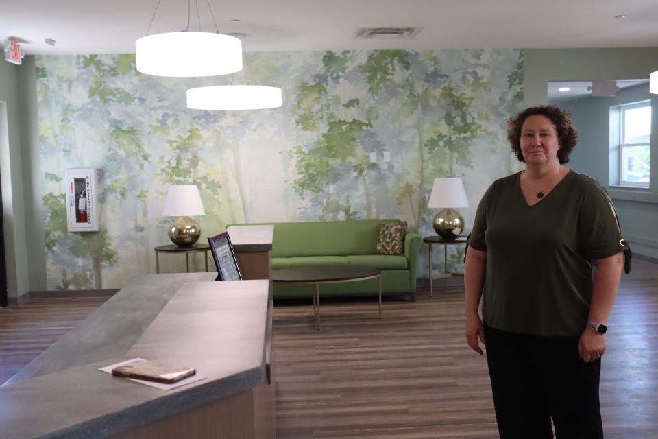 Grace House Akron Executive Director Holly Klein stands in the family room of the house, which will offer end-of-life care for residents who are homeless or in financial need.