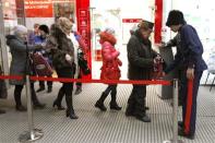 A Russian Cossack checks the bags of visitors to a trade centre in the southern Russian city of Volgograd, January 7, 2014. REUTERS/Vasily Fedosenko