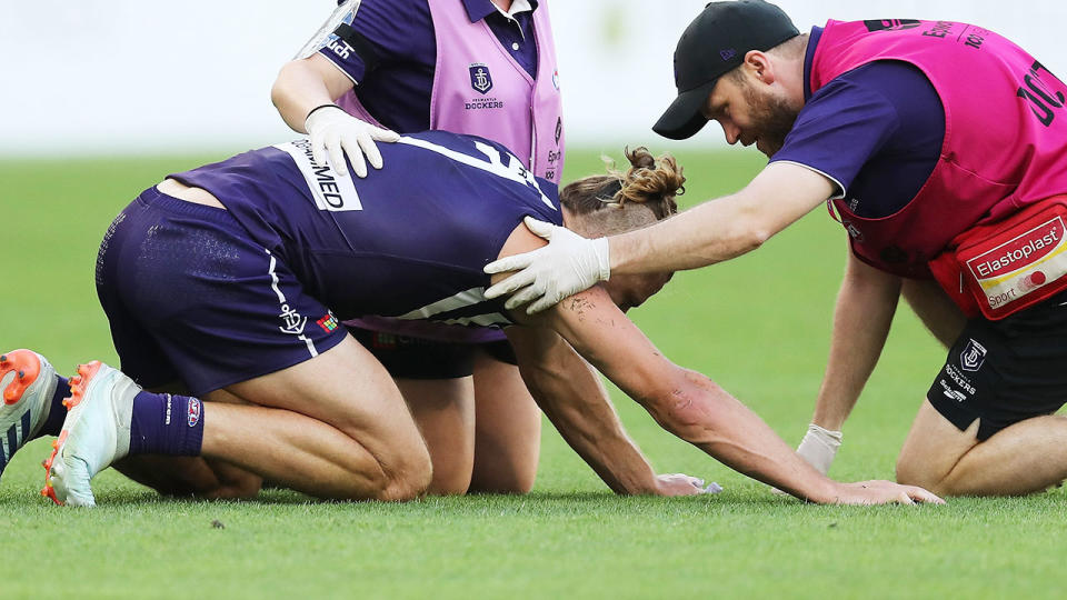 Nat Fyfe, pictured here heavily concussed after a brutal hit from Sam Reid.