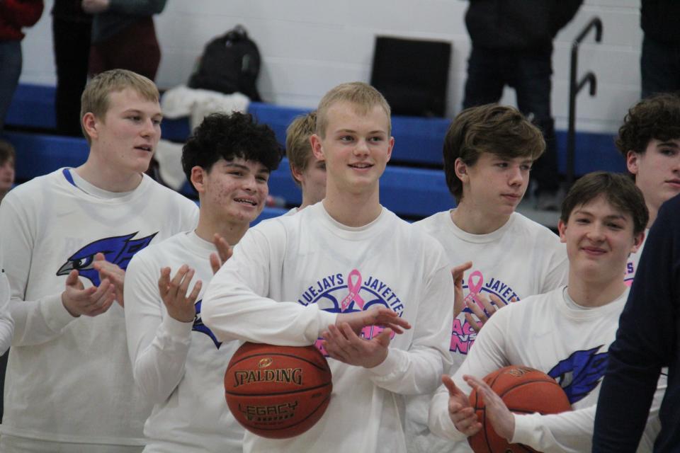 Perry boys basketball players applaud a donation made by the Iowa Wolves to the Perry Booster Club during a basketball doubleheader against Greene County on Tuesday, Feb. 6, 2024, at Perry High School.