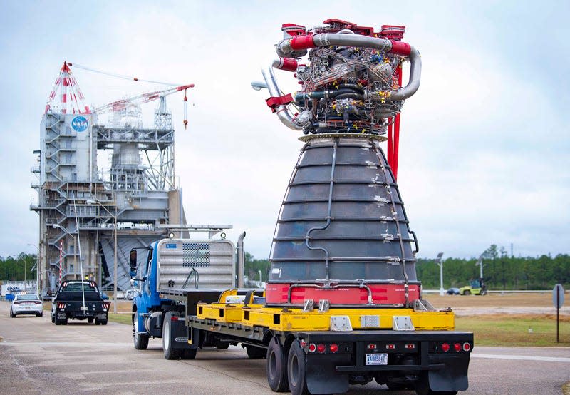 The engine, designated E10001, being delivered to the test stand at Stennis 