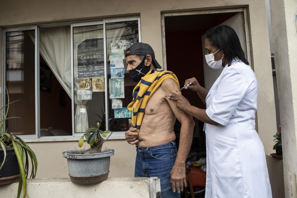 Andre Luiz da Silva, 70, is injected with a dose of the Pfizer COVID-19 vaccine during a third dose campaign for elderly residents in long-term care institutions, at a retreat for elderly artists, in Rio de Janeiro, Brazil, Wednesday, Sept. 1, 2021. Some cities in Brazil are providing booster shots of the COVID-19 vaccine, even though most people have yet to receive their second jabs, in a sign of the concern in the country over the highly contagious delta variant. (AP Photo/Bruna Prado)