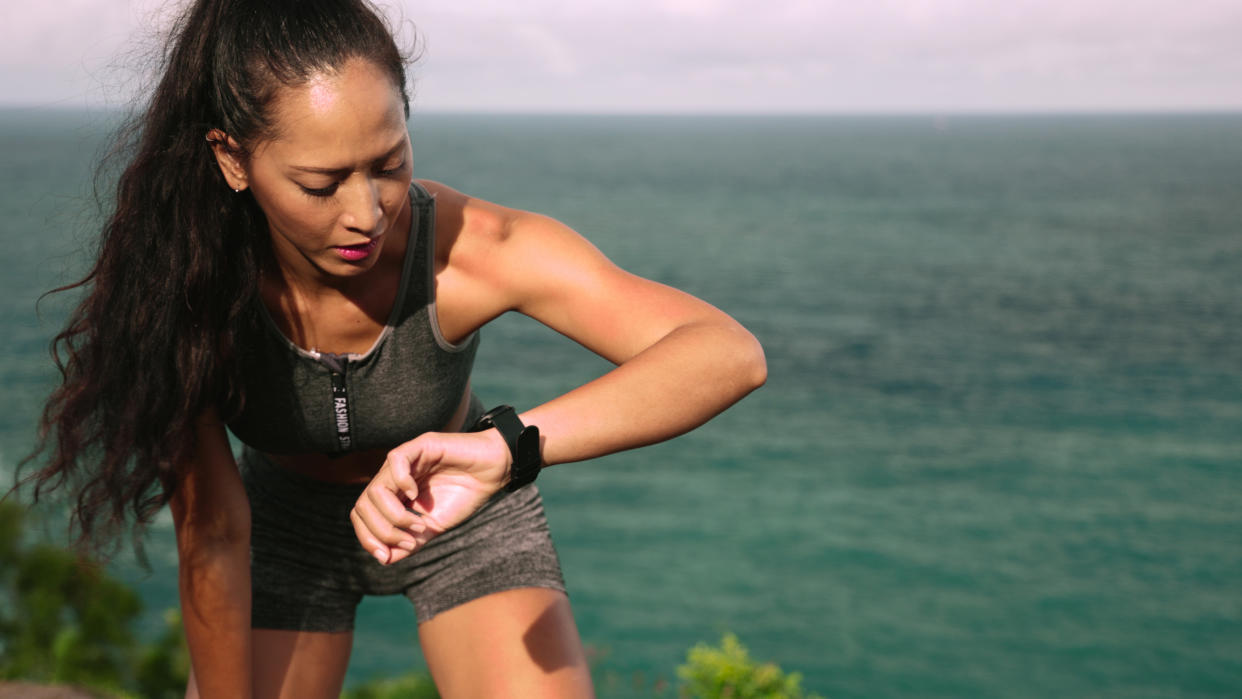  Woman checking sports watch during workout 