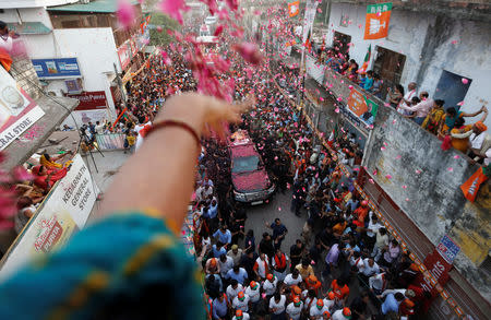 A supporter throws flower petals on India's Prime Minister Narendra Modi during a roadshow in Varanasi, India, April 25, 2019. REUTERS/Adnan Abidi