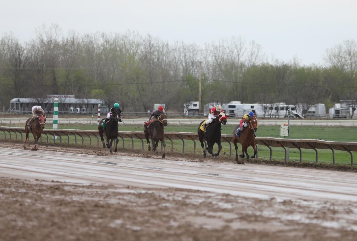 Michael Davila Jr., a jockey, who rode Kaufy Futures, starts his move to take and keep the lead over Nazario Alvarado, who is riding Christmas Dinner, at Finger Lakes Gaming & Racetrack in Farmington, April 26, 2022.