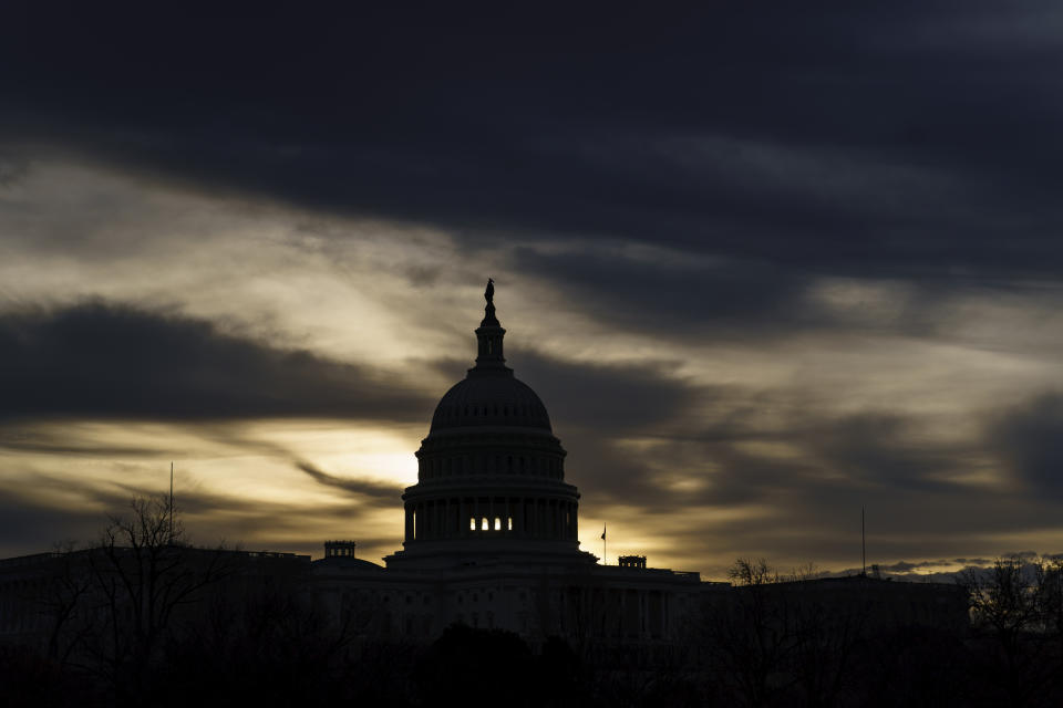 FILE - The U.S. Capitol is seen in Washington, early Dec. 17, 2021. President Joe Biden faces a steep path to achieve his ambitious goal to slash planet-warming greenhouse gas emissions in half by 2030, as a $2 trillion package of social and environmental initiatives remains stalled. Biden’s Build Back Better plan, which contains $550 billion in spending and tax credits aimed at promoting clean energy, was sidetracked by Democratic Sen. Joe Manchin, who said just before Christmas that he could not support the legislation as written. (AP Photo/J. Scott Applewhite, File)