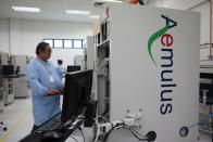 FILE PHOTO: Employee of automated the test equipment designer and solutions provider Aemulus Holdings Berhad works at a production facility in Penang