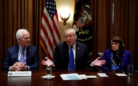 Flanked by Senators John Cornyn (R-TX) and Dianne Feinstein (D-CA) U.S. President Donald Trump meets with bi-partisan members of Congress to discuss school and community safety in the wake of the Florida school shootings at the White House in Washington, U.S., February 28, 2018. REUTERS/Kevin Lamarque