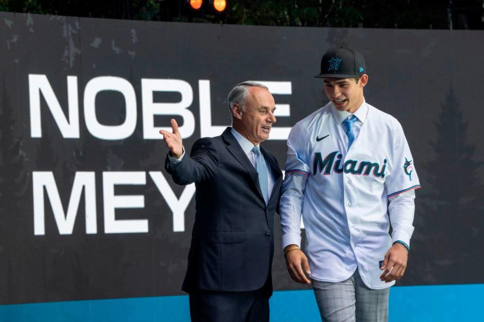 Miami Marlins draft pick Noble Meyer, right, is introduced by commissioner Rob Manfred during the first round of the MLB Draft at Lumen Field.
