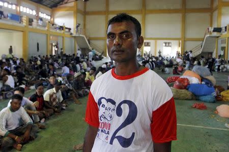 Mohammad Husein, a 29-year-old migrant from the Rohingya community in Myanmar who arrived in Indonesia with 600 others on a boat, poses for a photograph inside a temporary shelter in Lhoksukon, Indonesia's Aceh Province May 13, 2015. 2015. REUTERS/Roni Bintang