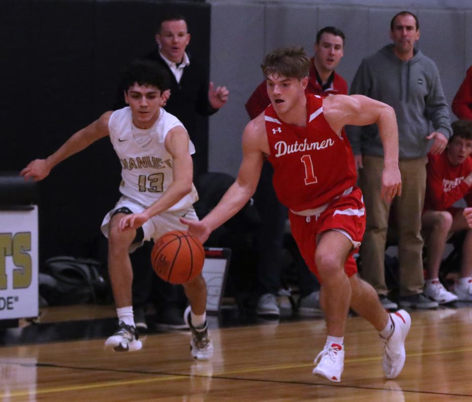 Tappan Zee's Sean Berrigan runs past Nanuet's Evan Nerves during their game at Nanuet Jan. 19, 2023. Tappan Zee won 69-39.