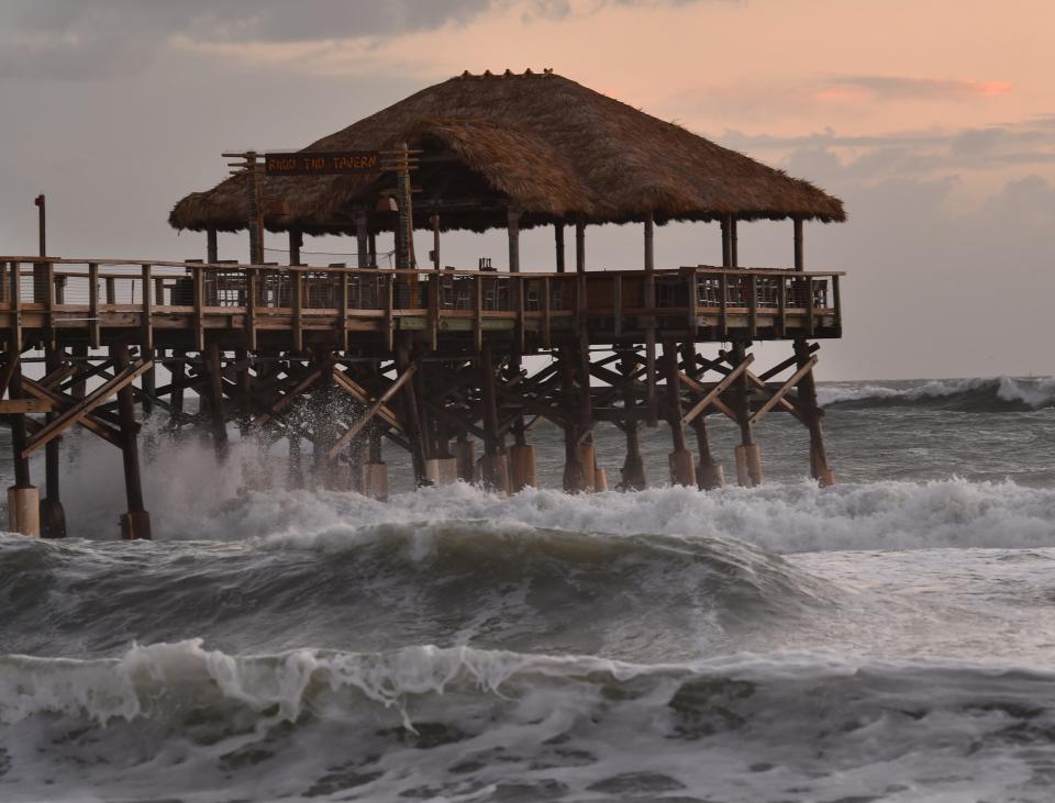 Tropical Storm Nicole and the full moon generate big waves and high surf Tuesday morning at the Cocoa Beach Pier.