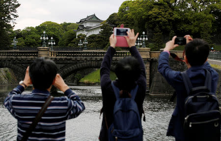 Visitors take photos of the Imperial Palace in Tokyo, Japan, April 29, 2019. REUTERS/Kim Kyung-hoon