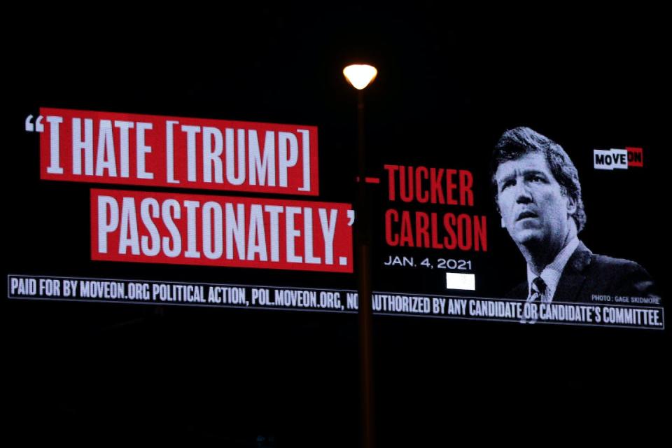 An image of former Fox News Channel host Tucker Carlson and his view of Donald Trump are displayed on a billboard in West Palm Beach, Fla. <a href="https://www.gettyimages.com/detail/news-photo/billboard-put-up-by-progressive-activist-group-moveon-that-news-photo/1479574560?adppopup=true" rel="nofollow noopener" target="_blank" data-ylk="slk:Alex Wong/Getty Images;elm:context_link;itc:0;sec:content-canvas" class="link ">Alex Wong/Getty Images</a>