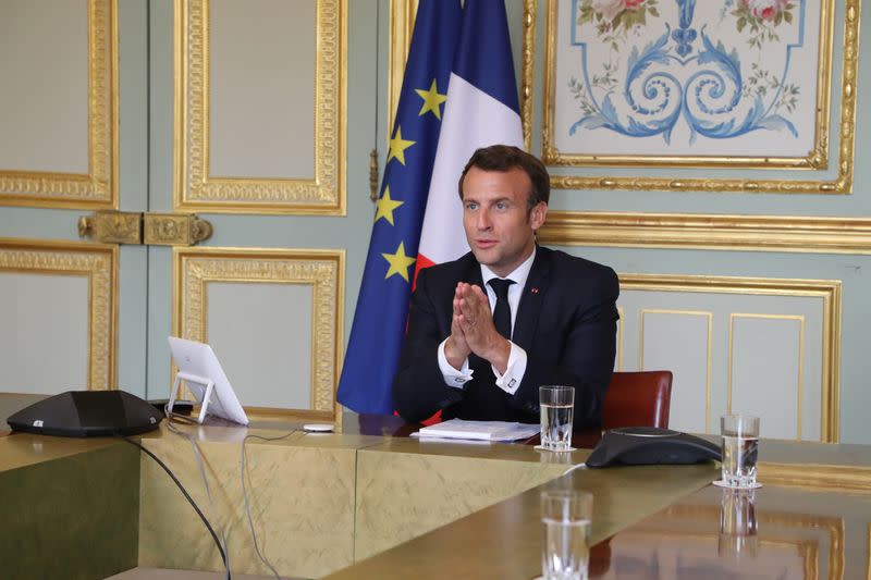 French President Emmanuel Macron takes part in a video conference with World Health Organization (WHO) general director Tedros Adhanom Ghebreyesus in Paris