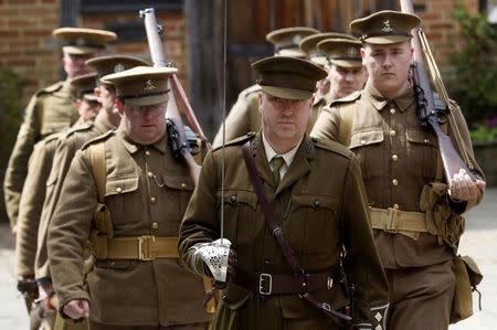 Theatre nurse Ciaran Dukes (C) portraying a Captain in the Royal Army Medical Corps marches with other re-enactors depicting World War One drills at the Eden Valley Museum at Edenbridge in south east England May 10, 2014. REUTERS/Luke MacGregor