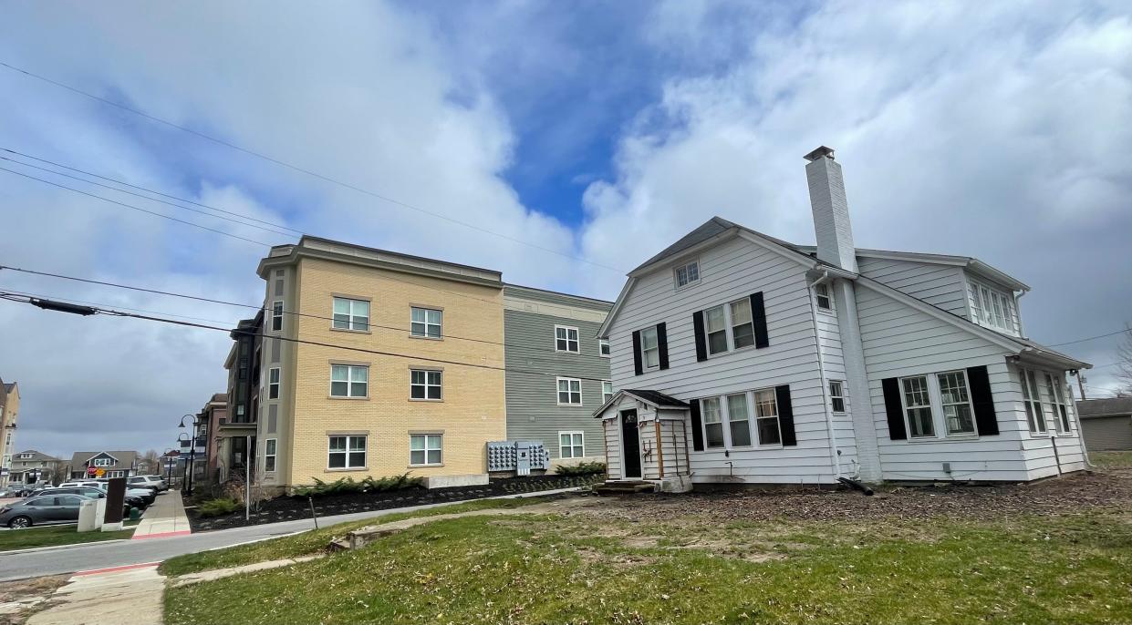 Legendary Notre Dame football coach Knute Rockne's first home in South Bend, right, sits across an alley from a luxury student housing complex called The Foundry at Eddy Street Commons. Developers are proposing the home be moved a half-mile west to make way for new condos.