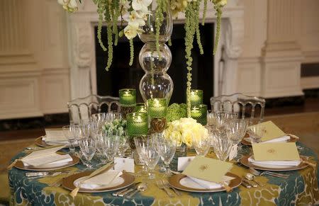 Place settings and floral arrangements for the State Dinner welcoming Canadian Prime Minister Justin Trudeau and his wife Sophie Gregoire Trudeau are seen during a press preview in the State Dining Room of the White House in Washington March 9, 2016. REUTERS/Gary Cameron