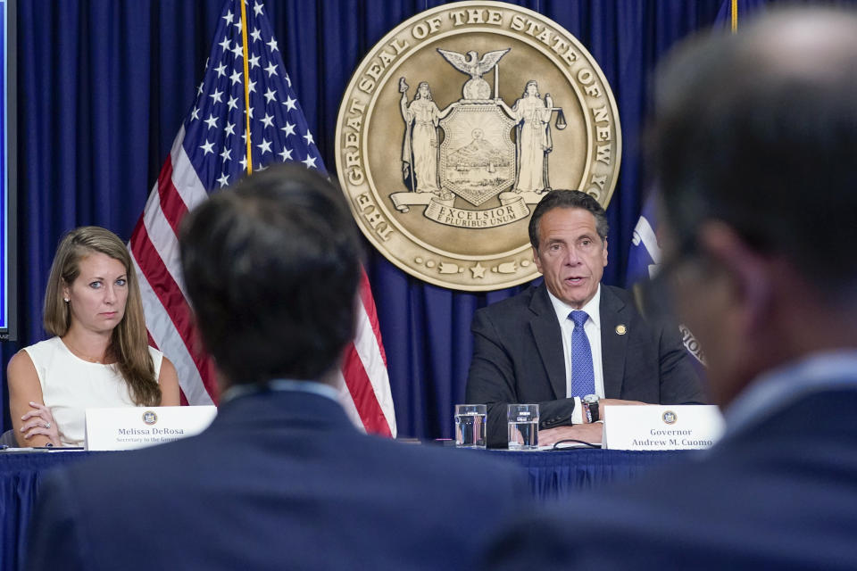 FILE - Secretary to the Governor Melissa DeRosa, left, listens as New York Gov. Andrew Cuomo speaks to reporters during a news conference, Wednesday, June 23, 2021, in New York. DeRosa resigned Sunday, Aug. 8 a week after a report found the governor sexually harassed 11 women. (AP Photo/Mary Altaffer, File)