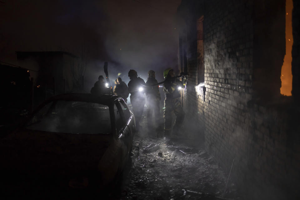 Firefighters extinguish a fire after a Russian attack on a residential neighborhood in Kharkiv, Ukraine Saturday, Feb. 10, 2024. (AP Photo/Yevhen Titov)