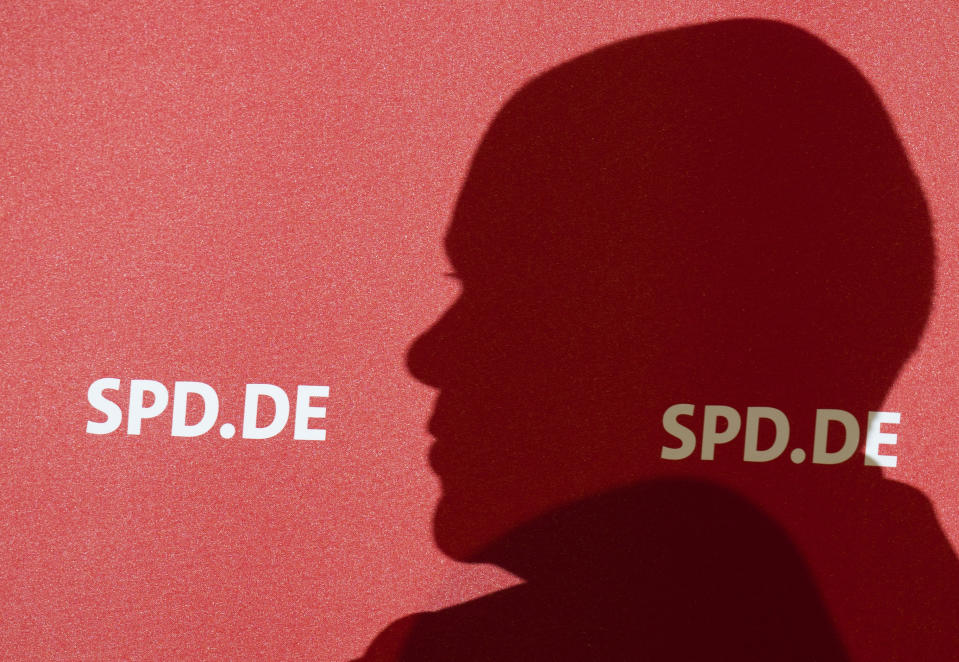 German Finance Minister and Social Democratic Party, SPD, candidate for chancellor Olaf Scholz casts his shadow on a billboard during an election campaign event named: 'Future talk with employees' in Wolfsburg, Germany, Tuesday, Sept. 21, 2021. (Julian Stratenschulte/dpa via AP)