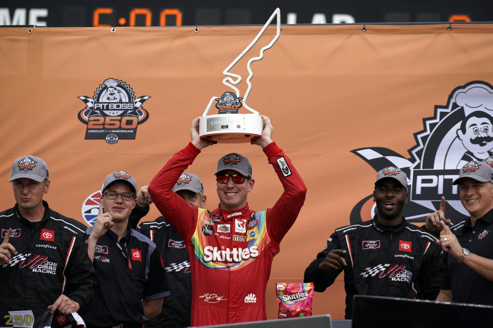 Kyle Busch raises the trophy in Victory Lane after winning the NASCAR Xfinity Series auto race at the Circuit of the Americas in Austin, Texas, Saturday, May 22, 2021. (AP Photo/Chuck Burton)