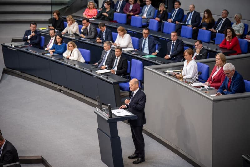Germany's Chancellor Olaf Scholz speaks at a government statement on the EU and NATO summits in the German Bundestag. Michael Kappeler/dpa