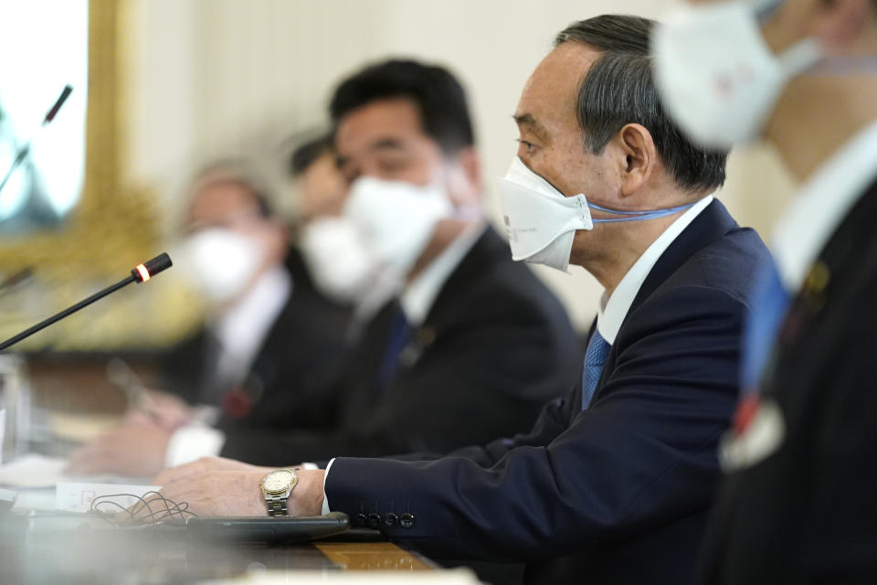 Japanese Prime Minister Yoshihide Suga listens as President Joe Biden speaks in the State Dining Room of the White House, Friday, April 16, 2021, in Washington. (AP Photo/Andrew Harnik)