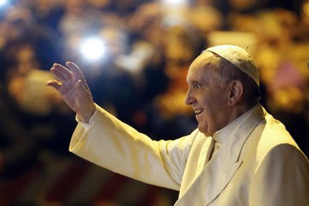 Pope Francis waves as he leaves after visiting the parish of San Michele Archangelo in Rome February 8, 2015. REUTERS/Giampiero Sposito