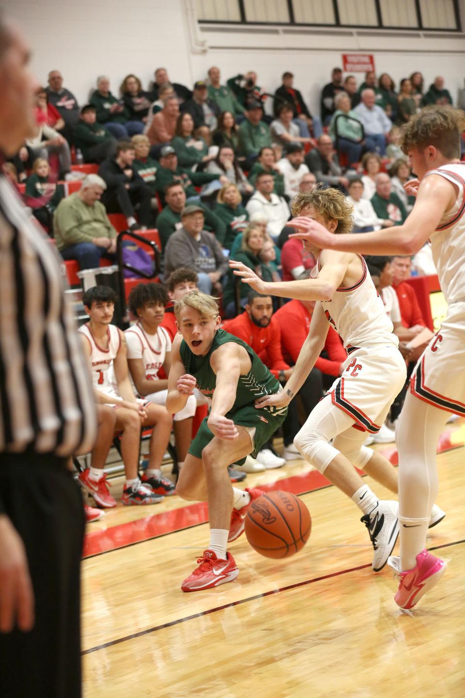 Oak Harbor's Carson Slates passes inside.