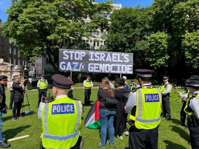 Supporters of protest group Youth Demand holding a sign that says 'Stop Israel's Gaza Genocide'